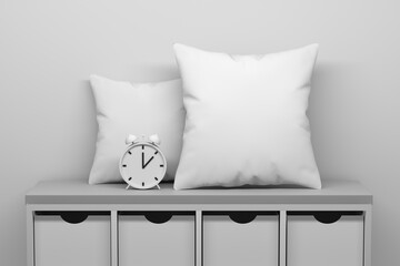Mockup template with two white blank pillows and clock standing on cabinet with drawers - obrazy, fototapety, plakaty