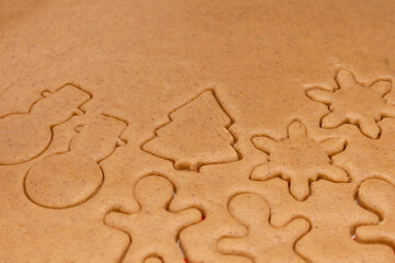 Background rolls out the dough with cookie cutters at the kitchen