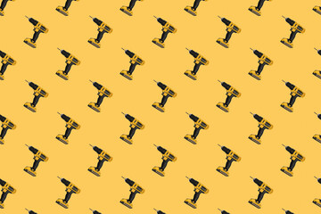 Seamless pattern. Cordless electric yellow screwdriver on a yellow background.