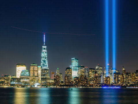 Night view of the 911 memorial light and the New York City skyline