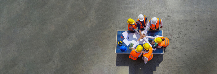 Top view of Architect engineers working on solar panel and blueprints. Technology solar cell,...