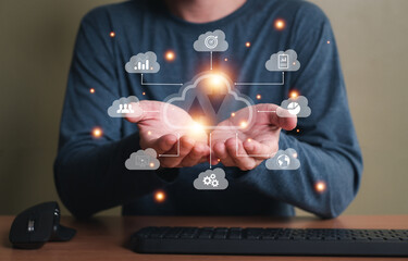 Selective focus at the icon with hand of human that holding cloud icon while who using internet and personal cloud storage to keep information and payment data, upload over the internet.