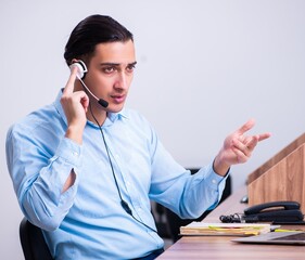Call center operator working at his desk