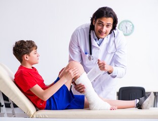 Leg injured boy visiting young doctor traumatologist