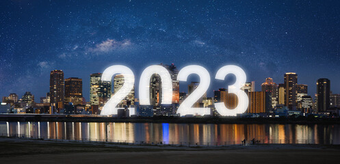 New Year 2023 in the city. Panoramic city at night with starry sky - obrazy, fototapety, plakaty