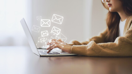 Email marketing and newsletter concept. Woman using computer laptop and sending online message with email icon - obrazy, fototapety, plakaty