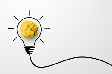 Creative thinking ideas and innovation concept. Paper scrap ball yellow colour with light bulb...