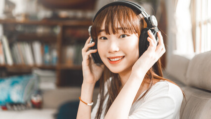 Portrait of young adult asian woman wear headphone listen music lifestyle with wireless technology