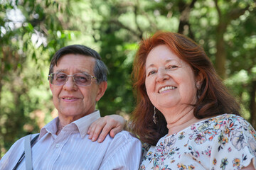 Fototapeta premium Senior Hispanic couple enjoying time together in a park, outdoors. Concepts: enjoyment of nature, active retirement.