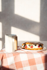 Sweet dessert with strawberry, blueberry and mint on table. Continental breakfast with coffee mug.