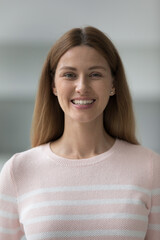 Vertical shot beautiful young woman wear pink knitted jumper pose indoors, standing at home smile staring at camera look happy feel satisfied. Fashion, lifestyle, single female photoshoot, portrait