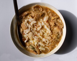 Myanmar traditional or classic white flat noodle fish soup called Khauk Swe.