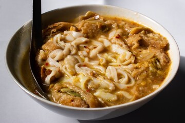 Myanmar traditional or classic white flat noodle fish soup called Khauk Swe.