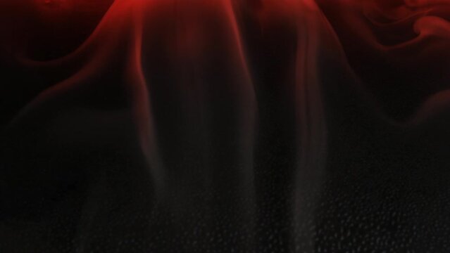 slow motion white dry ice smoke on black and red backgrounds