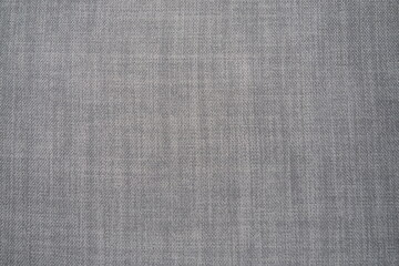 Fototapeta na wymiar gray background fabric texture. A piece of woolen cloth is neatly laid out on the surface. Weave and textile texture. Dress fabric or for kitchen needs, tablecloth or curtains, close-up. Dash