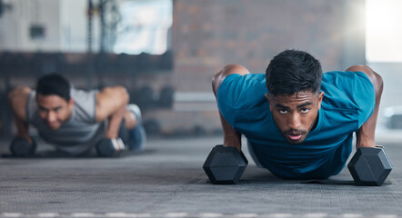 Fitness, dumbbell weights and men doing a push up exercise for strength, health and wellness in a gym. Sports, motivation and athletes doing a workout or training routine together in a sport center.