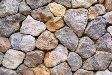 modern hard stones stack or rock wall dam and brown gray granite floor or black yellow stone jigsaw on top view for strong background or texture backdrop and wallpaper with architectural construction