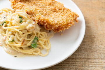 spaghetti pasta white cream sauce with fried fish
