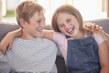 Children, siblings and hug on sofa laughing for sister and brother fun relaxing together at home....