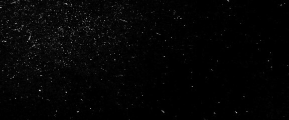 Abstract glitter background, snow imitation in silver, on black, white scratches isolated on a black background. template for design.