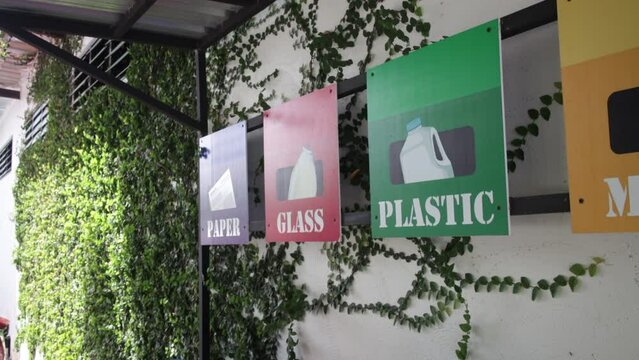 Empty bottle. Plastic garbage bin trash container. Hand bottle into recycle bin.