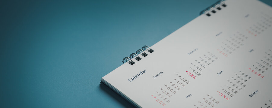 Embroidered red pins on a calendar event Planner calendar,clock to set timetable organize schedule,planning for business meeting or travel planning concept.