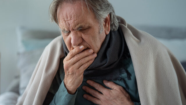 Portrait of coughing old man