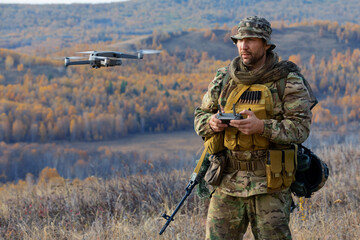An artillery spotter or military observer launches a drone into the sky for reconnaissance in enemy...