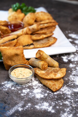 assorted national Asian pastries on the table on a gray background top view