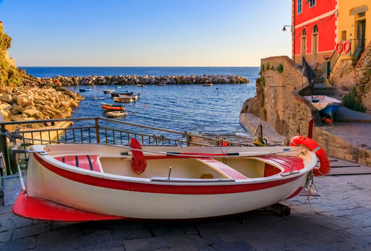Mediterranean Sea, colorful boats and houses, Riomaggiore in Cinque Terre, Italy