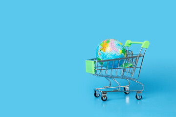 Internet shopping, online purchases, international delivery, planet earth in a trolley, copy space