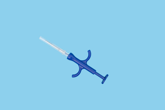 pet chipping, syringe with microchip on blue background