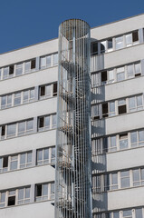 Fototapeta premium circular metal fire escape. multi-floor apartment. spiral staircase,