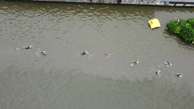 Downview with a drone on open water swimming during a triathlon race