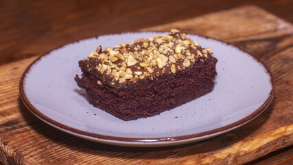 Piece of chocolate cake brownie On a blue plate. Calories in a piece of chocolate cake