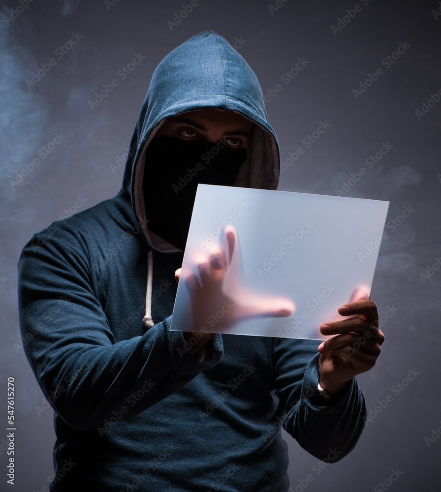 Aufkleber hacker working on tablet in dark