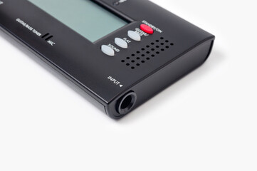 Fototapeta premium Tuner for tuning a bass guitar, compact, on a white background.