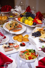 the table in the room is set in red tones with food for the holiday
