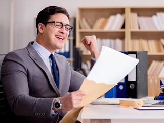 Businessman receiving letter envelope in office