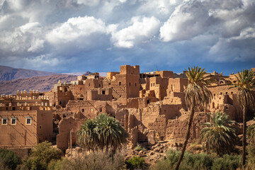 Fototapeta na wymiar kasbah, valley of roses, morocco, oasis, river, m'goun, high atlas mountains, north africa, dramatic sky