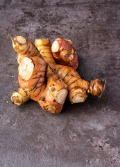 Fresh Galangal isolated on dark background.