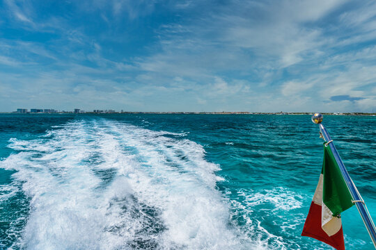 Mexican flag on ship boat ferry in Caribbean Ocean near Cancun, Yucatan, Mexico
