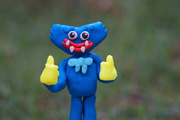 A bright blue monster made of plasticine. A character for children. Ideas for Halloween.