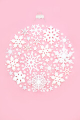 Christmas tree snowflake bauble round shape decoration on pink background. Festive ornate abstract...