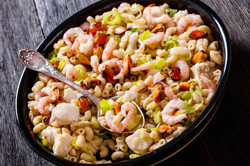 macaroni salad with shrimps, mussels, fish, leek