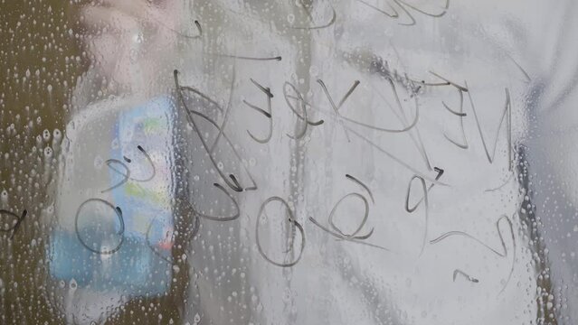 Washing sharpie marker from window with cleaning spray and squeegee