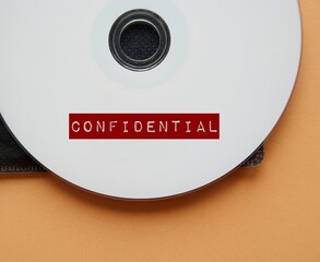 CD with red label CONFIDENTIAL concept of data or information intended to be kept secret, something...