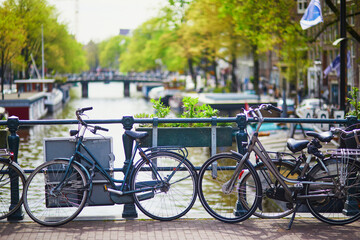 Fototapeta na wymiar Bicycles parked on a bridge in Amsterdam