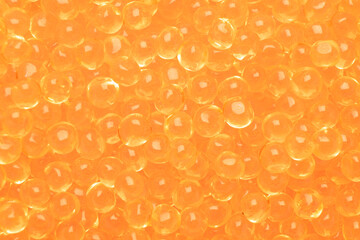 Background texture of salmon fish red caviar. Macro shot trout caviar texture pattern.