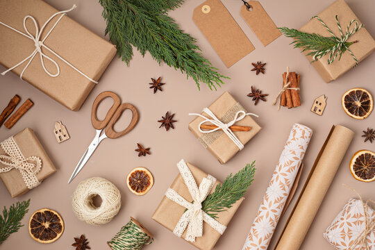 Christmas Background With Gift Boxes And Kraft Wrapping Paper. Xmas Celebration, Preparation For Winter Holidays. Festive Mockup, Top View, Flatlay